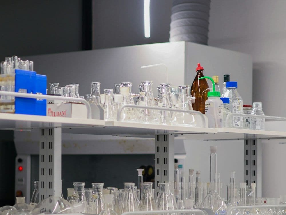 Laboratory shelving lined with glassware used for specialty formulation work