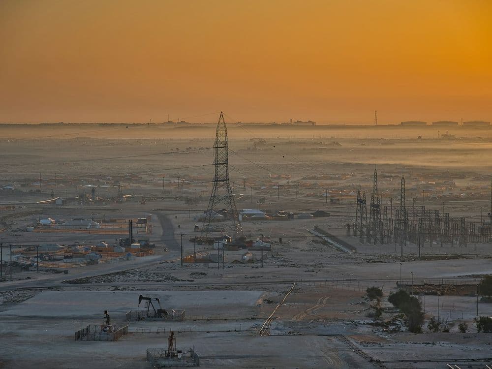 Pump jacks operating at a desert oilfield at dusk